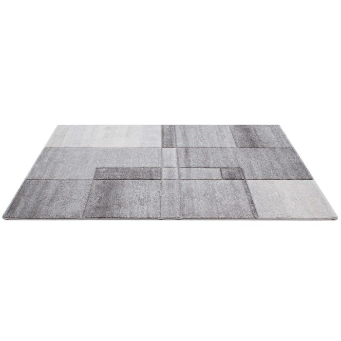 Tappeto moderno con motivo geometrico nei toni del grigio e argento.
