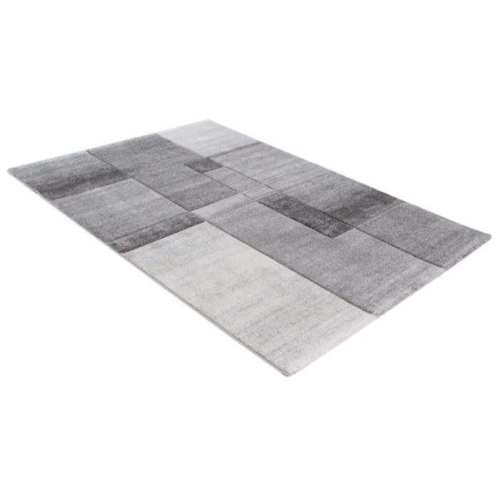 Tappeto moderno con motivo geometrico nei toni del grigio e del bianco.