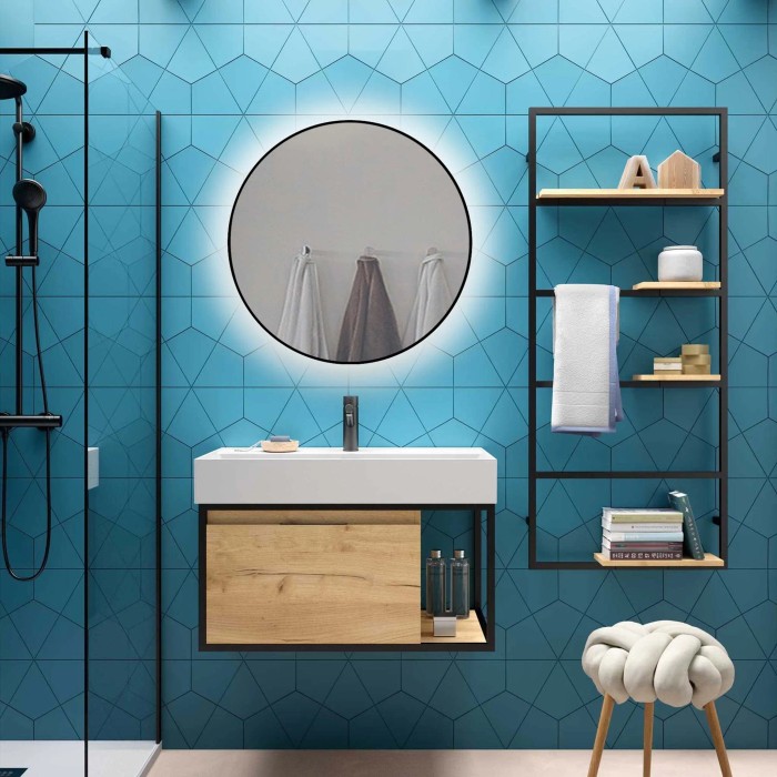 Bagno con specchio da parete rotondo e mobile lavabo.