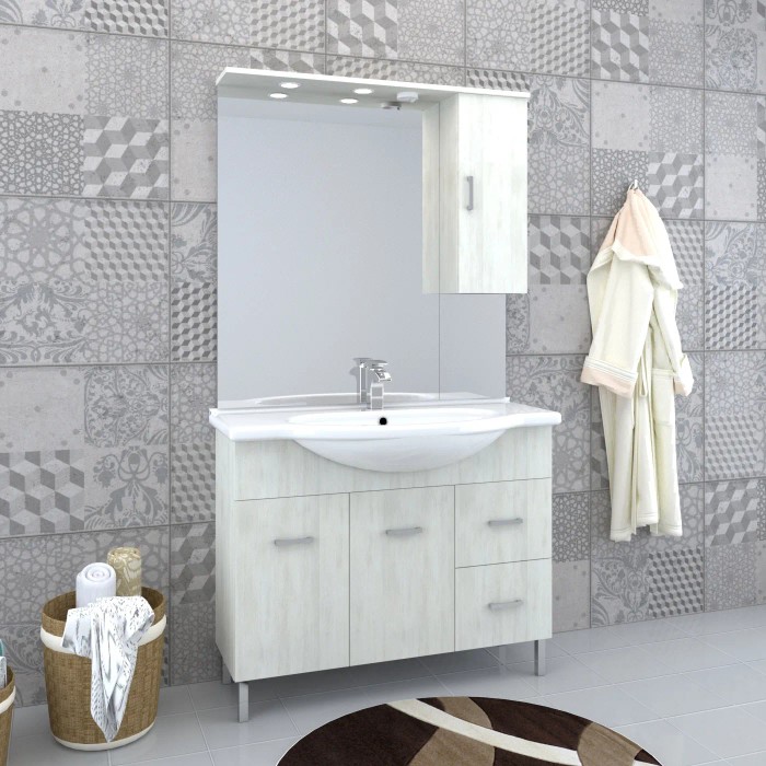 Set di mobili da bagno chiari con lavabo, specchio e armadietto per il bagno.