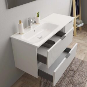Mobile bagno bianco con due cassetti e lavabo da appoggio per il bagno.