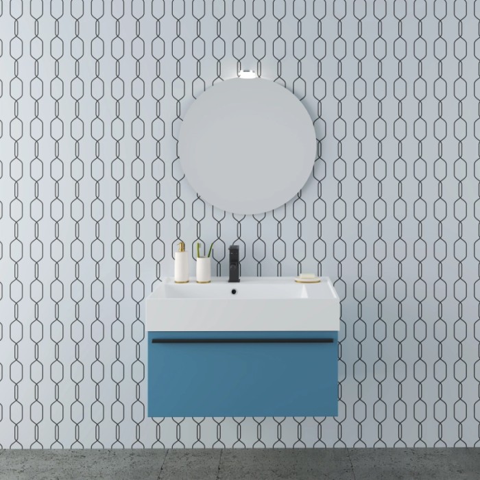 Set di mobili da bagno blu con specchio rotondo e lavabo da appoggio moderno.