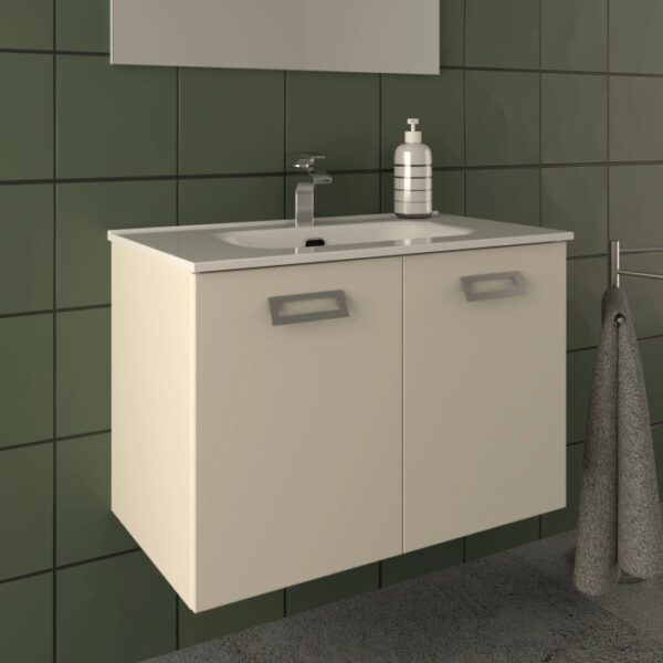 Mobile bagno beige con lavabo e rubinetto su parete verde.