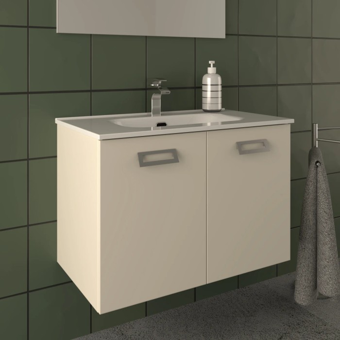 Mobile bagno beige con lavabo e rubinetto su parete verde.