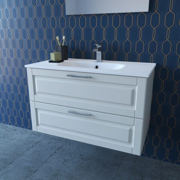 Mobile bagno bianco con due cassetti e lavabo da appoggio su parete blu decorata.