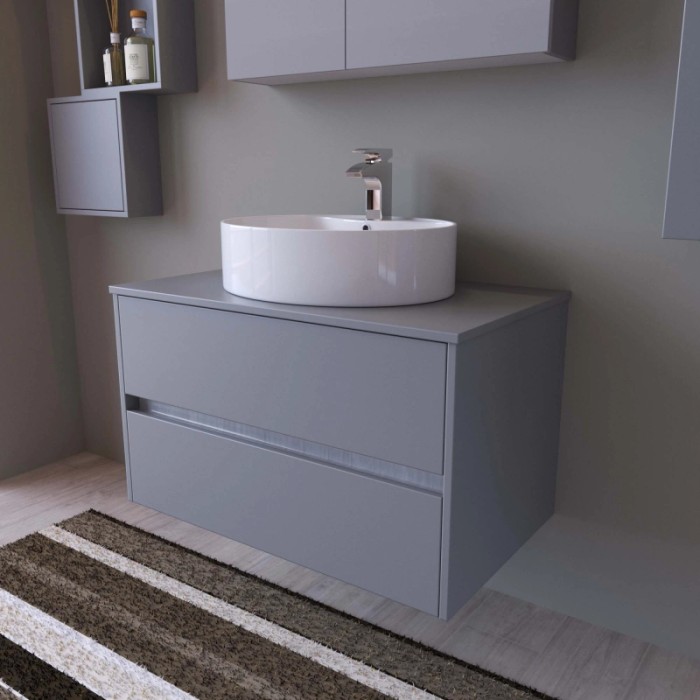 Mobile bagno grigio con lavabo d'appoggio, parte della serie di mobili bagno.