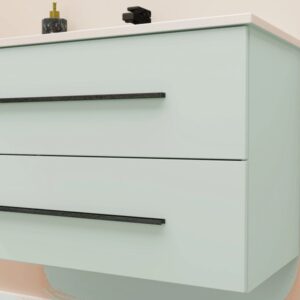 Mobile bagno color menta con due cassetti e maniglie nere.