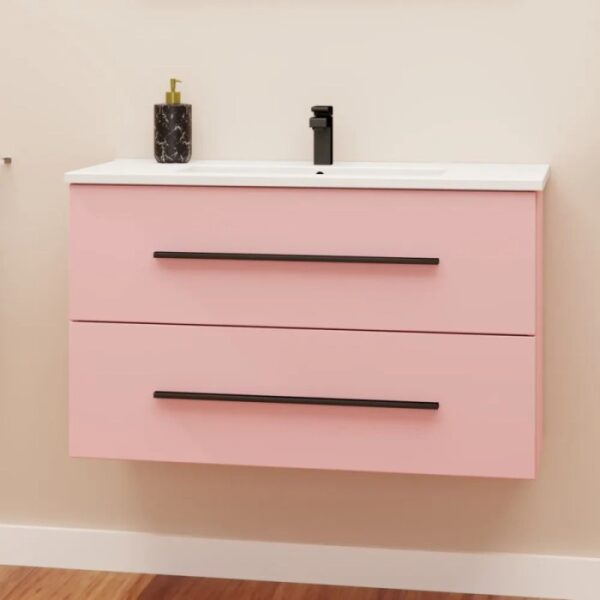 Mobile bagno rosa con due cassetti, rubinetto nero e dispenser di sapone.