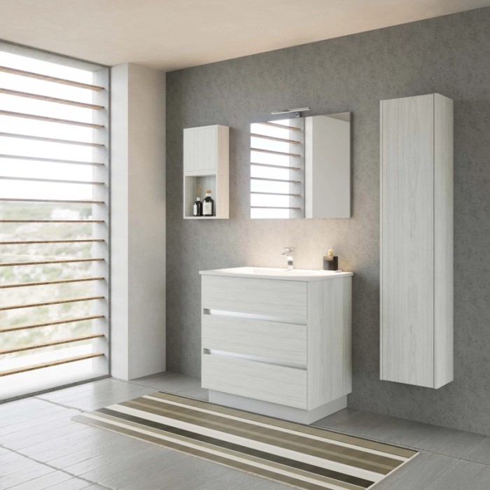 Set bagno moderno con lavabo, specchiera e mobile alto in legno chiaro.